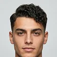 Match: a man with similar features and a short curly side part